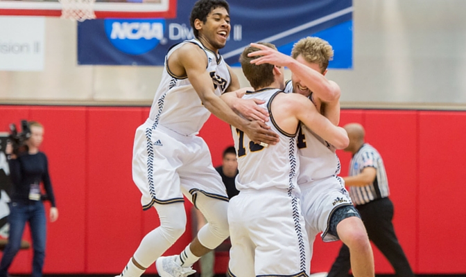 Adam Klie (13) is congratulated by teammates after his buzzer-beater lifted UC San Diego into the NCAA West Regional title game. Photo by cjimagesnw.com.